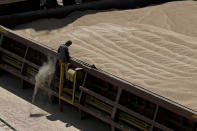 An employee of the Romanian grain handling operator Comvex oversees the unloading of Ukrainian cereals from a barge in the Black Sea port of Constanta, Romania, Tuesday, June 21, 2022. While Romania has vocally embraced the ambitious goal of turning into a main hub for the export of agricultural products from Ukraine, economic experts and port operators in the country warn that it was much easier objective to set than to actually achieve. (AP Photo/Vadim Ghirda)