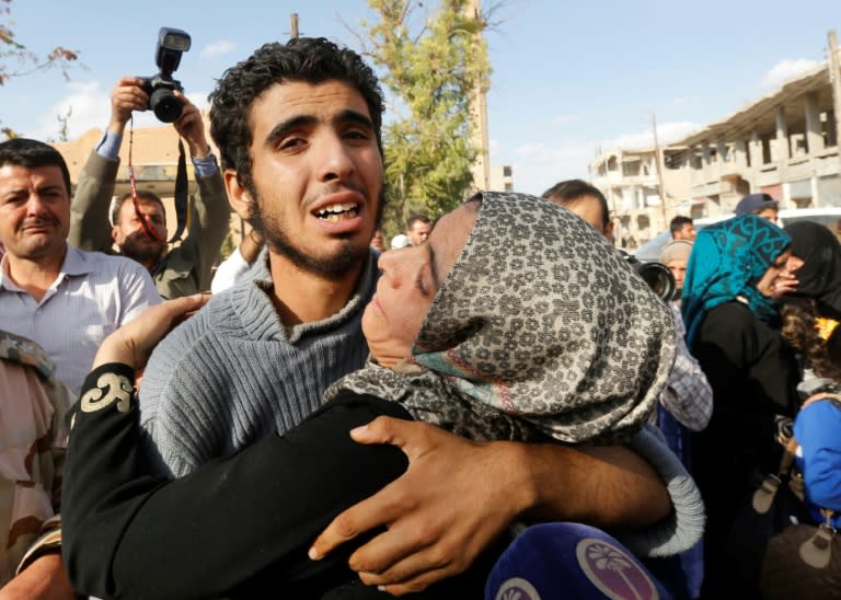 A Syrian man from the recently retaken desert town of Al-Qaryatain is greeted by relatives on October 29, 2017, after the Syrian army reportedly freed him from Islamic State (IS) group detention