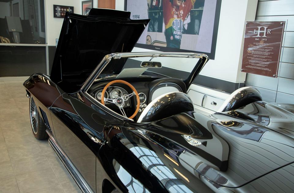 Rick Hendrick's 1963 black Corvette is on display in the lobby of the 58,000-square-foot Heritage Center in Concord, North Carolina on July 25, 2023. This was Hendrick's first Corvette. He bought it in 1971 as a stock 1963 Corvette and it was the car he took his wife in for their first date. It broke down and Hendrick fixed it on the side of the road that night. Later, he and his wife, Linda, sold the car along with most of their assets to raise money to buy his first dealership. In the early 2000s he found the car and bought it back. It was turned into a resto-mod, which is a vintage car that retains much of the original look of the vehicle but is built with modern technology. He and Linda drove it earlier this year for their 50th wedding anniversary.