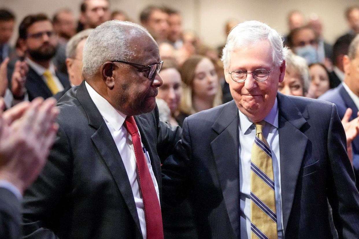 Thomas and Senate Minority Leader Mitch McConnnell, with McConnell grinning widely.