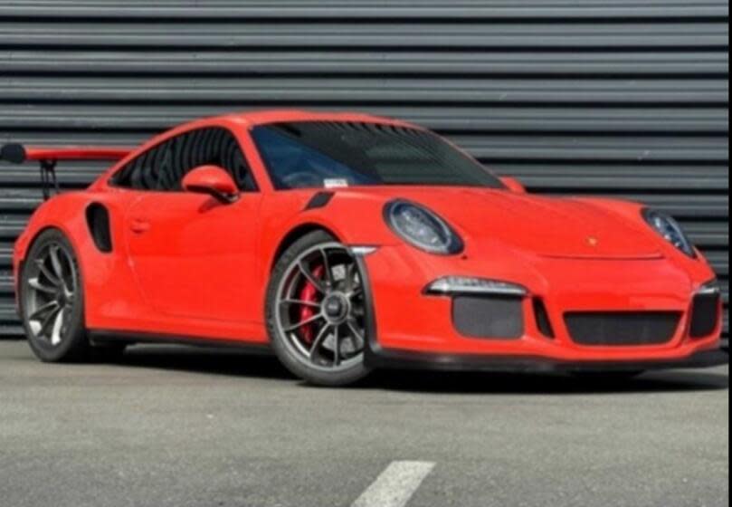 A red Porsche is parked.