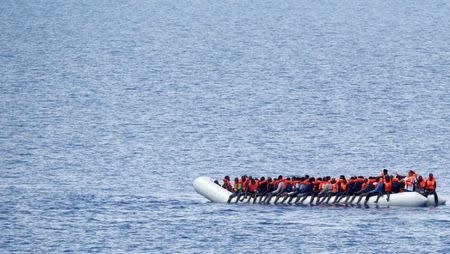 FILE PHOTO: Migrants wait to be rescued by "Save the Children" NGO crew in the Mediterranean sea off Libya coast, June 18, 2017. REUTERS/Stefano Rellandini/File Photo