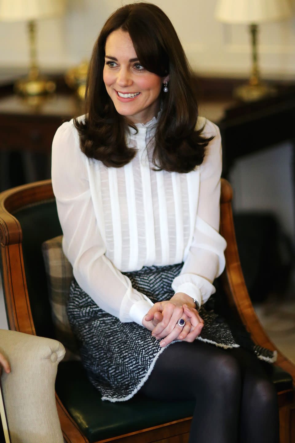 <p>The Duchess knows the power of a black + white ensemble, pairing her high collar blouse with a tweed skirt for a polished look as Guest Editor of The Huffington Post. </p>