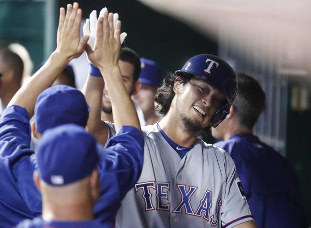 Yu Darvish celebrates his unexpected but historic first MLB home run. (AP)