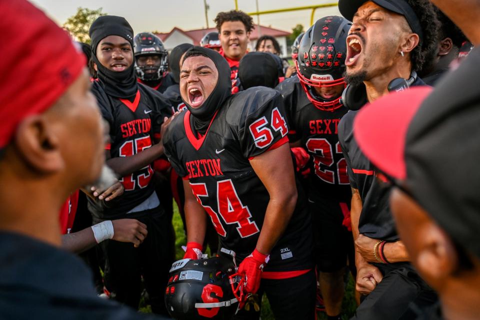 Sexton's Isaiah Moore, center, and the rest of the J-Dubbs celebrate after beating Charlotte on Friday, Sept. 15, 2023, at Sexton High School in Lansing.