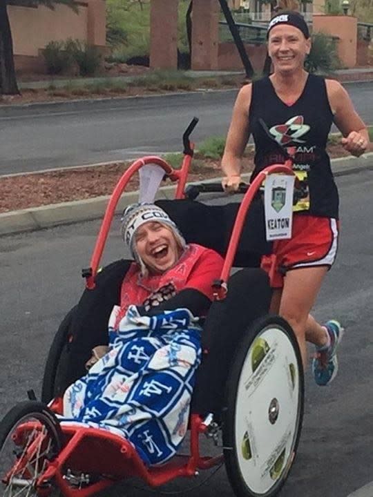 <em>Rider athlete Keaton Mabry and his runner Michele Maloney race to the finish line. (Credit: Dawn Sabraw)</em>