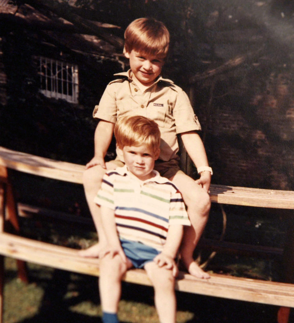 Prince William and Prince Harry sit together on a picnic bench.&nbsp;