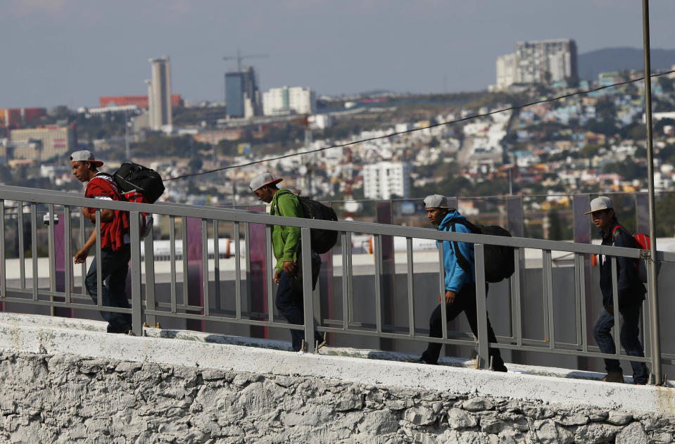 Central American migrants arrive in Queretaro, Mexico, as they resume their journey north after leaving the temporary shelter in Mexico City, Saturday, Nov. 10, 2018. Thousands of Central American migrants were back on the move toward the U.S. border Saturday, after dedicated Mexico City metro trains whisked them to the outskirts of the capital and drivers began offering rides north. (AP Photo/Marco Ugarte)