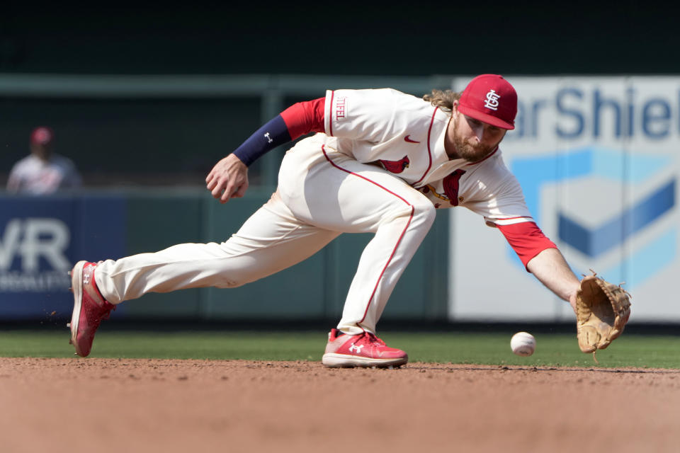 St. Louis Cardinals second baseman Brendan Donovan dives for a ground ball by Cincinnati Reds' Spencer Steer before throwing Steer out at first during the ninth inning of a baseball game Saturday, June 10, 2023, in St. Louis. (AP Photo/Jeff Roberson)