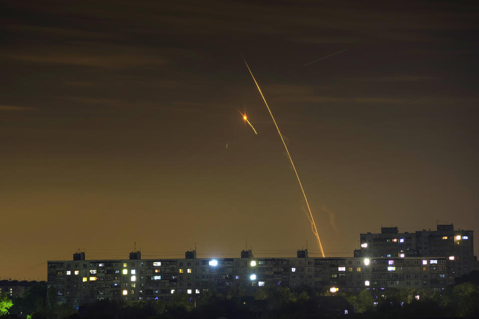 Russian rockets launch against Ukraine from Russia's Belgorod region are seen at dawn in Kharkiv, Ukraine, early Sunday, May 14, 2023. (AP Photo/Vadim Belikov)