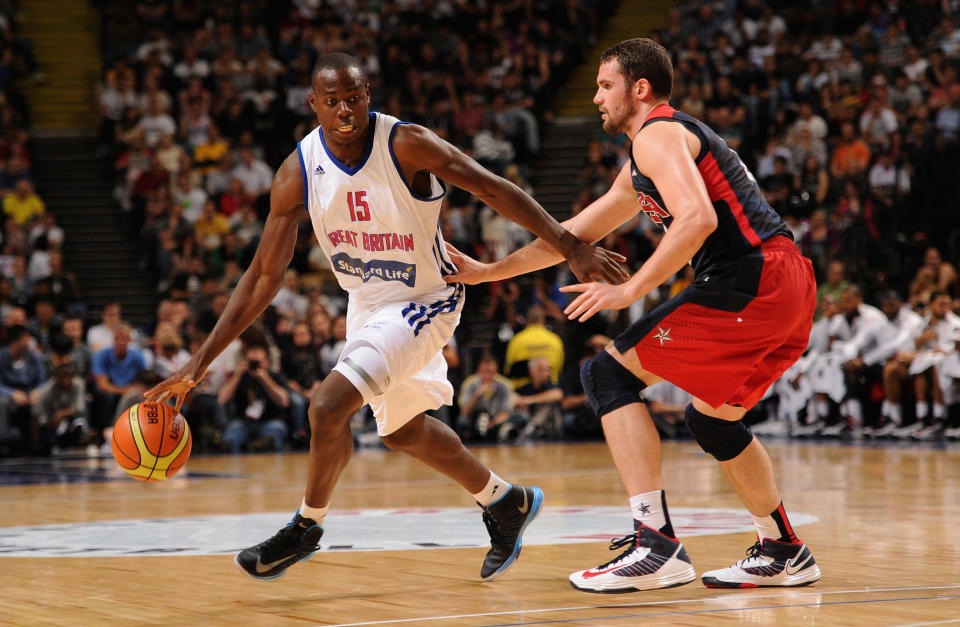 MANCHESTER, ENGLAND - JULY 19: USA player Kevin Love (r) battles for possesion of the ball with Eric Boateng of Team GB during the Men's Exhibition Game between USA and Team GB at Manchester Arena on July 19, 2012 in Manchester, England.