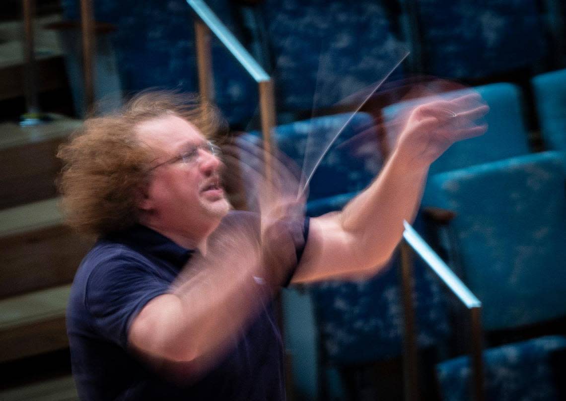 Stéphane Denève, artistic director, conducts the orchestra playing a Claude Debussy piece during a New World Symphony rehearsal on Thursday, Sept. 14, 2023, at the New World Center in Miami Beach. Denève asked the violins to play more “Halloweeny” because “I like to use different sensations to direct the sound I want.” Alie Skowronski/askowronski@miamiherald.com