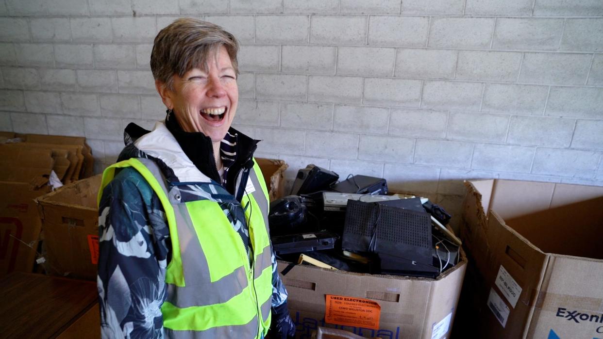 Michele Morris of Chittenden Solid Waste District stands next to a pile of electronic waste at CSWD's Williston drop-off center. Electronic waste cannot go in the trash or the blue recycling bin in Vermont. It can be brought to CSWD drop-off centers.