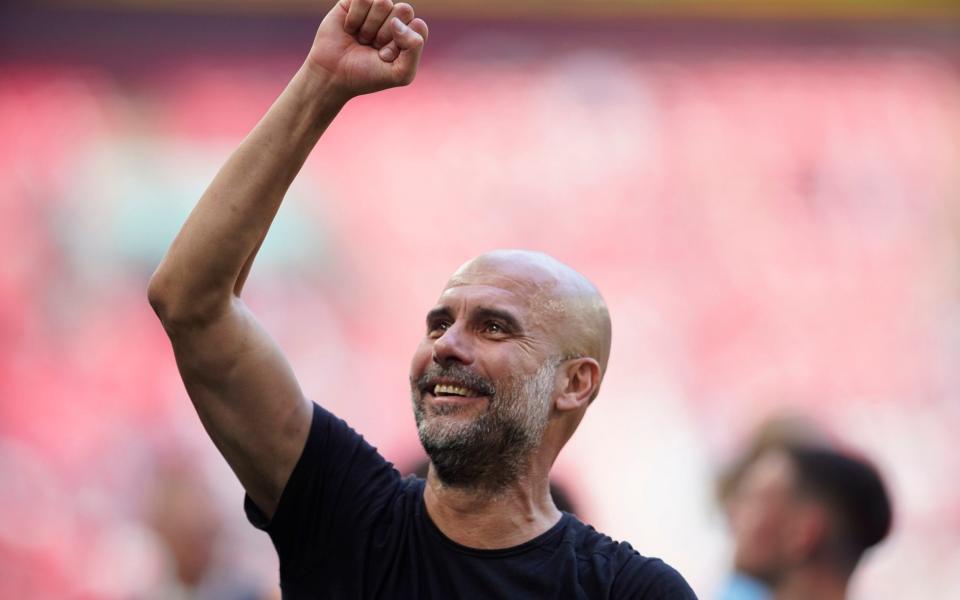 Manchester City's head coach Pep Guardiola celebrates after his team winning the English FA Cup final - AP/Dave Thompson