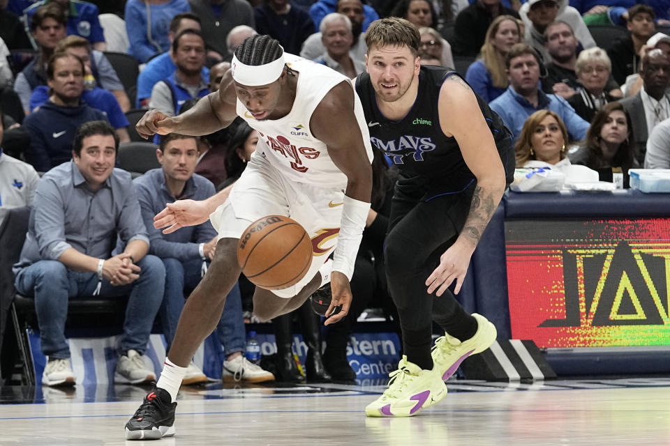 Cleveland Cavaliers guard Caris LeVert (3) gets by Dallas Mavericks guard Luka Doncic (77) during the second half of an NBA basketball game in Dallas, Wednesday, Dec. 27, 2023. (AP Photo/LM Otero)