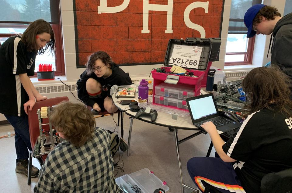 Coe-Brown Northwood Academy students Emerson Dwyer ‘23, Coryn Therrien ‘25, Michaela Linskey ‘24, Wes Perry ‘23, and Cecelia Mello ‘23 work on their robot at the Belmont High School meet on Jan. 14, 2023.