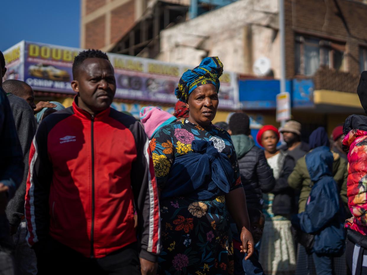 Relatives wait for news at the scene of the fire (AP)