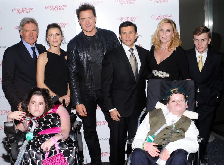  Actors Harrison Ford, Keri Russell and Brendan Fraser.pose with the real-life subjects of the film, John and Aileen Crowley pose with their children John Jr., standing, and Megan and Patrick at a screening of 'Extraordinary Measures' hosted by The Cinema Society on Thursday, Jan. 21, 2010 in New York. (AP Photo/Evan Agostini)