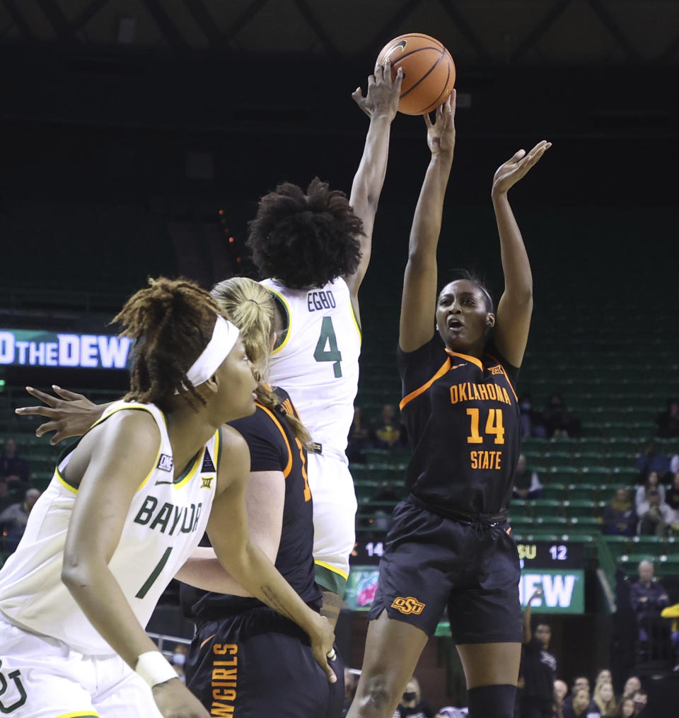 Baylor center Queen Egbo (4) blocks the shot of Oklahoma State forward Taylen Collins during the first half of an NCAA college basketball game Wednesday, Jan. 19, 2022, in Waco, Texas. (Rod Aydelotte/Waco Tribune-Herald via AP)