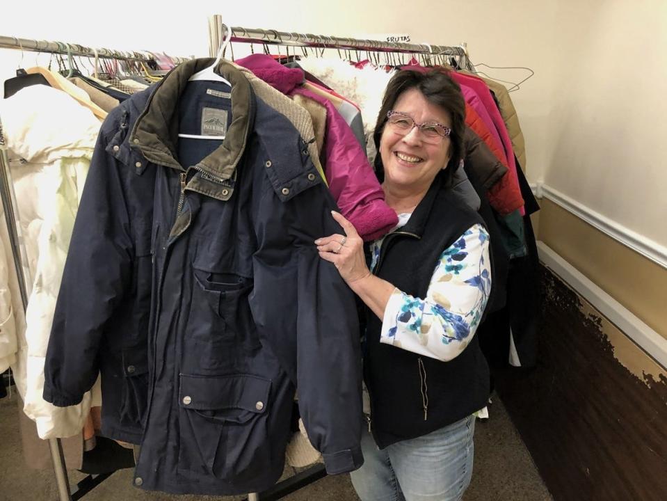 St. Vincent de Paul Society volunteer Jean Desrosiers examines winter coats donated by Dermody Cleaners in January 2019. .