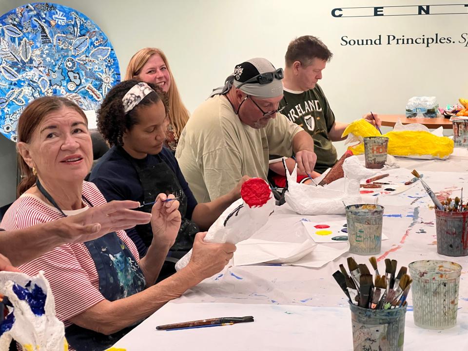 Telfair Museums' Outreach Program particpants paint their beasts at Savannah Speech and Hearing Center.