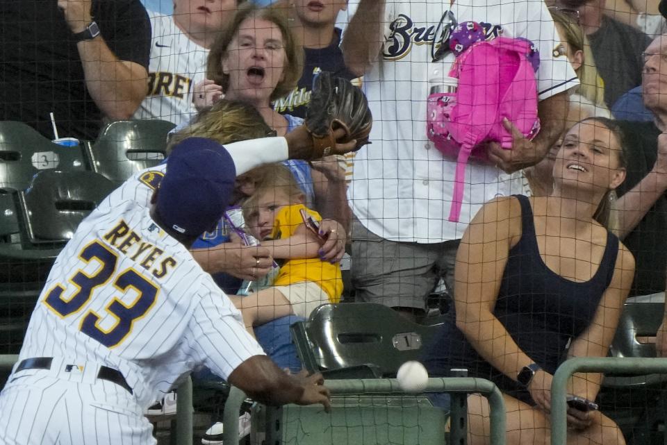 Milwaukee Brewers' Pablo Reyes can't catch a foul ball hit by Pittsburgh Pirates' Colin Moran during the third inning of a baseball game Saturday, June 12, 2021, in Milwaukee. (AP Photo/Morry Gash)