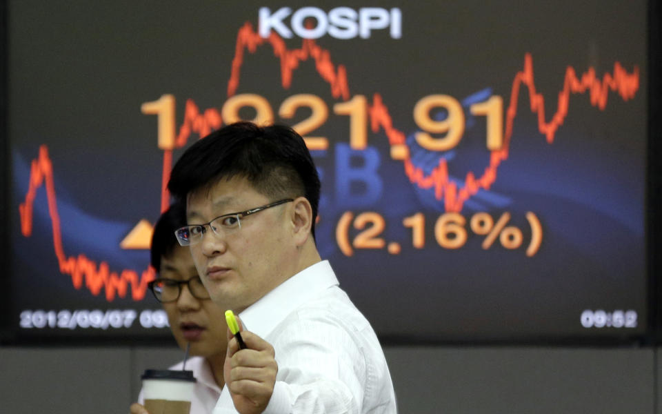 Currency traders talk to each other near a screen showing the Korea Composite Stock Price Index (KOSPI) at the foreign exchange dealing room of the Korea Exchange Bank headquarters in Seoul, South Korea, Friday, Sept. 7, 2012. Asian stock markets rallied Friday, boosted by strong advances on Wall Street and a highly anticipated plan to assist debt-riddled countries in the eurozone. (AP Photo/Lee Jin-man)