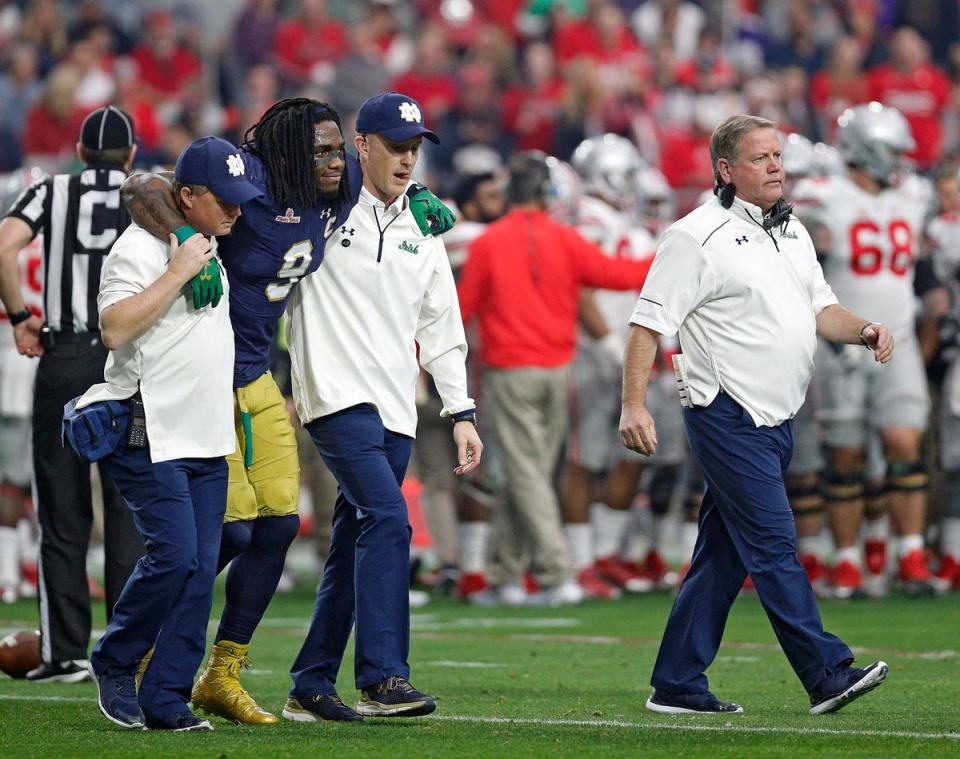 Notre Dame Fighting Irish linebacker Jaylon Smith (9) is helped off the field after an injury against Ohio State Buckeyes in the first quarter during the Fiesta Bowl in the University of Phoenix Stadium on January 1, 2016.