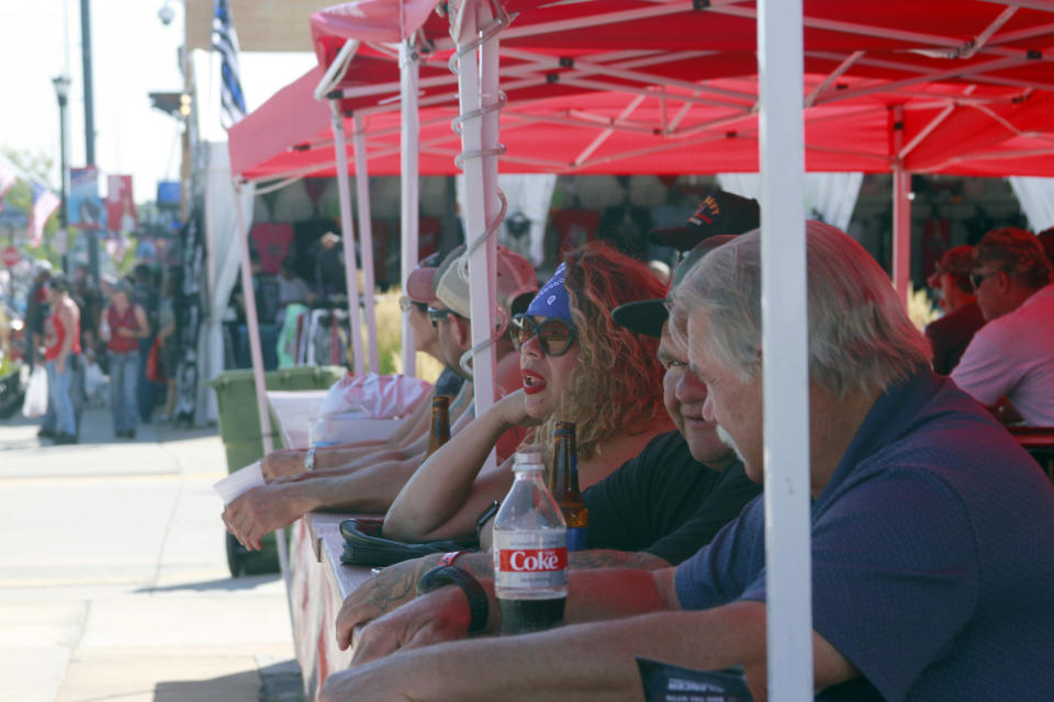 Thousands of bikers rode through the streets for the opening day of the 80th annual Sturgis Motorcycle rally Friday, Aug. 7, 2020, in Sturgis, S.D. Many at the rally defied coronavirus precautions like wearing face masks or social distancing. (AP Photo/Stephen Groves)