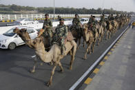 In this Feb. 21, 2020, photo, Border Security Force(BSF) soldiers march on the route that U.S. President Donald Trump will take in Ahmedabad, India. A festive mood has enveloped Ahmedabad in India’s northwestern state of Gujarat ahead of Prime Minister Narendra Modi's meeting Monday with U.S. President Donald Trump, whom he's promised millions of adoring fans. The rally in Modi's home state may help replace his association with deadly anti-Muslim riots in 2002 that landed him with a U.S. travel ban. Beyond the pageantry and symbolism of the visit, experts expect little to be achieved for either side. (AP Photo/Ajit Solanki)