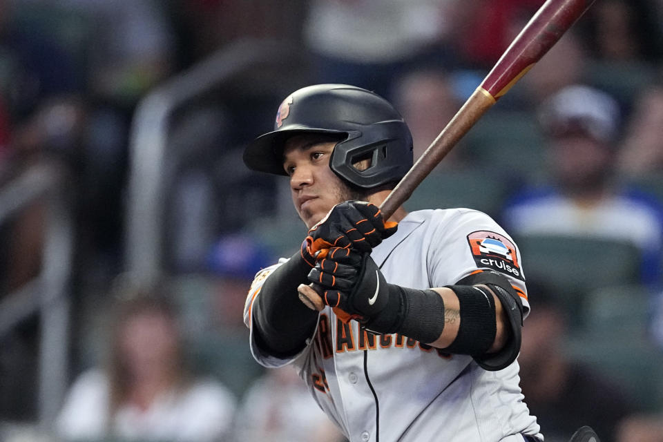 San Francisco Giants' Thairo Estrada drives in a run with a base hit during the fourth inning of the team's baseball game against the Atlanta Braves on Saturday, Aug. 19, 2023, in Atlanta. (AP Photo/John Bazemore)