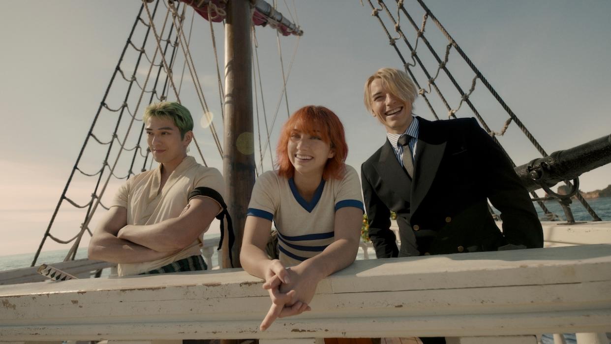  Zoro, Nami and Sanji smiling on board ship in live-action One Piece. 