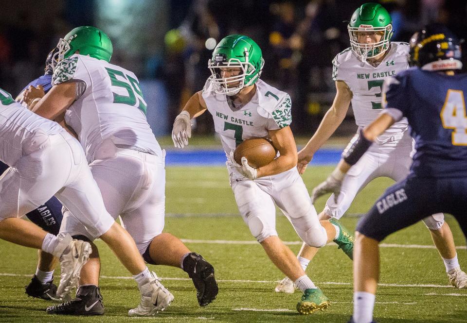 FILE -- New Castle's Jon Eberhart runs the ball against Delta's defense during their game at Delta High School Friday, Sept. 24, 2021.