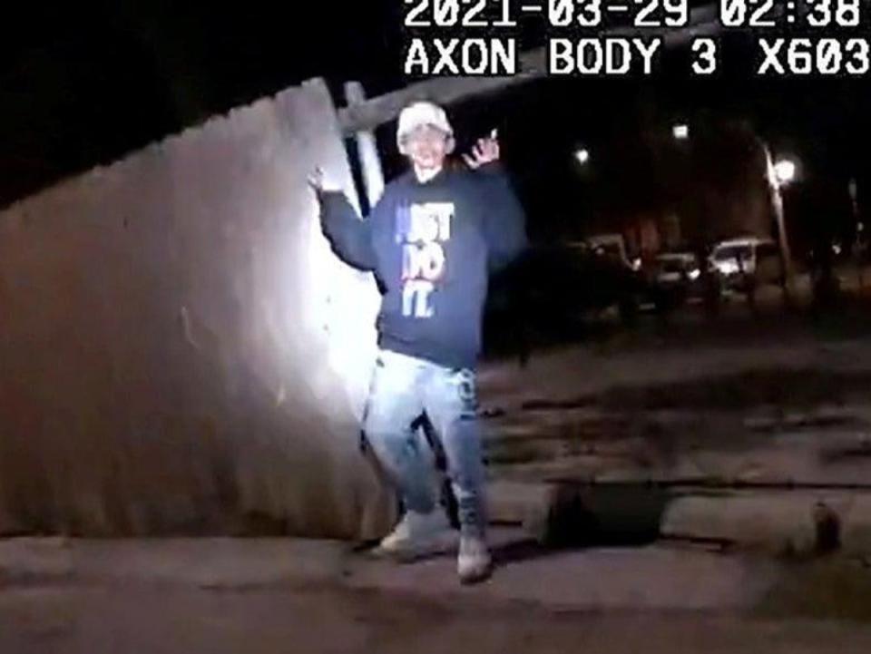 Adam Toledo, 13, holds up his hands a split second before he was shot by police (Reuters)