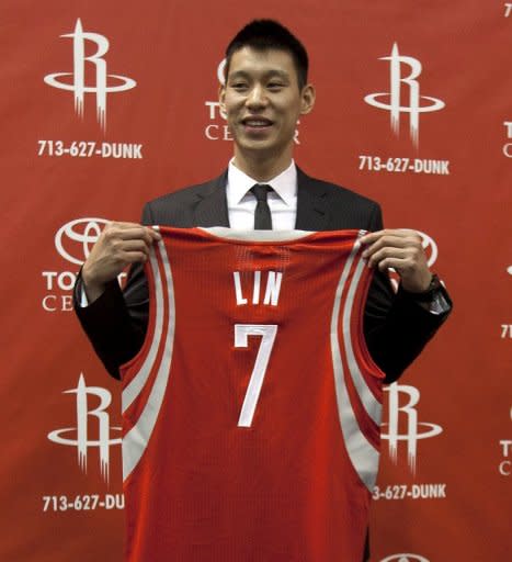 Jeremy Lin of the Houston Rockets displays his jersey during a press conference at Toyota Center, on July 19, in Houston, Texas