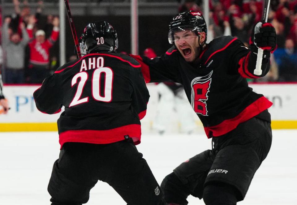 Feb 22, 2024; Raleigh, North Carolina, USA; Carolina Hurricanes center Sebastian Aho (20) is congratulated by defenseman Brett Pesce (22) after his goal against the Florida Panthers during the third period at PNC Arena.