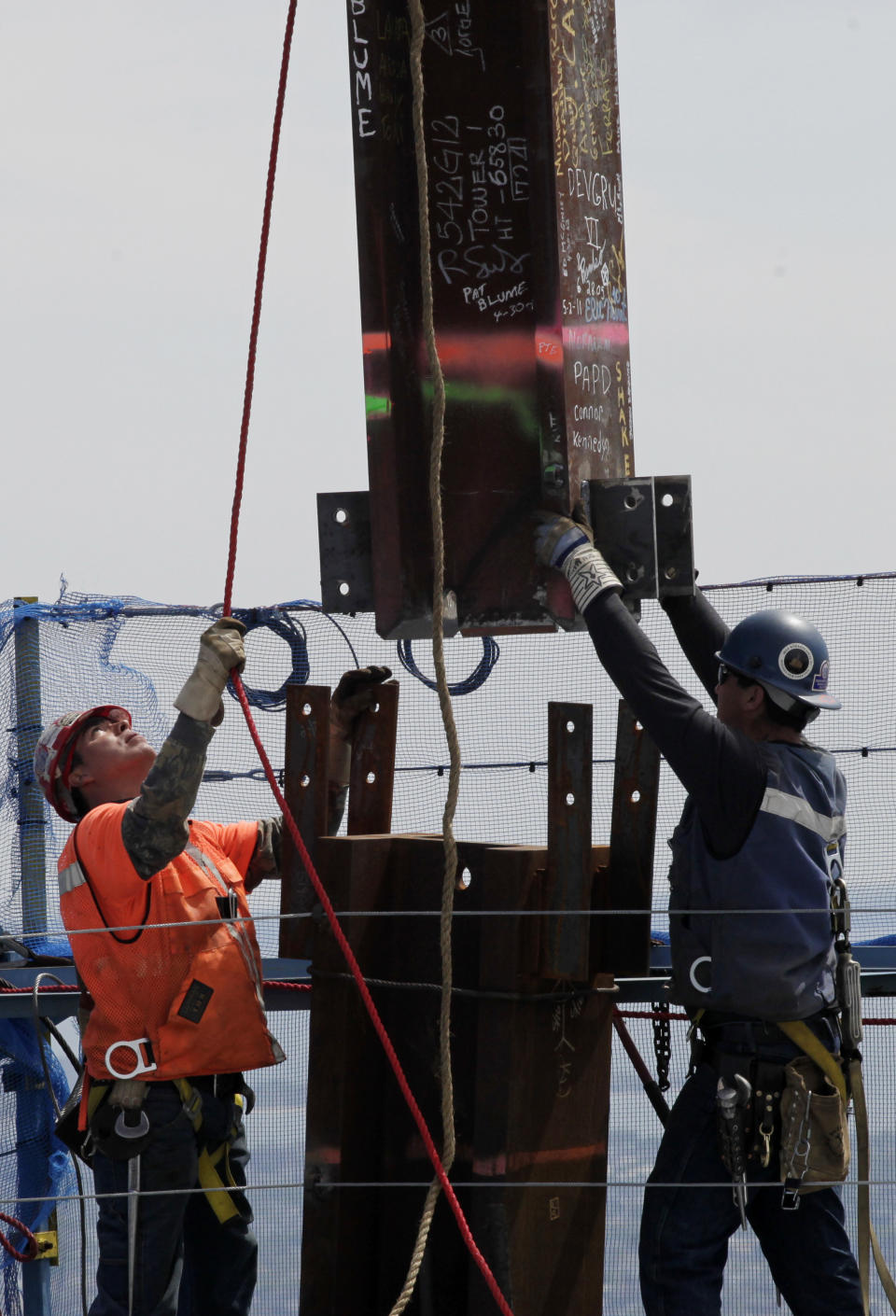 Ironworkers Adam Cross, left, and Steven Cross connect a steel beam between two columns at the top of One World Trade Center to make it New York City's tallest skyscraper, Monday, April 30, 2012 in New York. The cousins are from the Kahnawae native American reservation in Quebec, Canada. One World Trade Center is being built to replace the twin towers destroyed in the Sept. 11 attacks. It reached just over 1,250 feet on Monday. That's just taller than the observation deck on the Empire State Building. (AP Photo/Pool, Mark Lennihan)