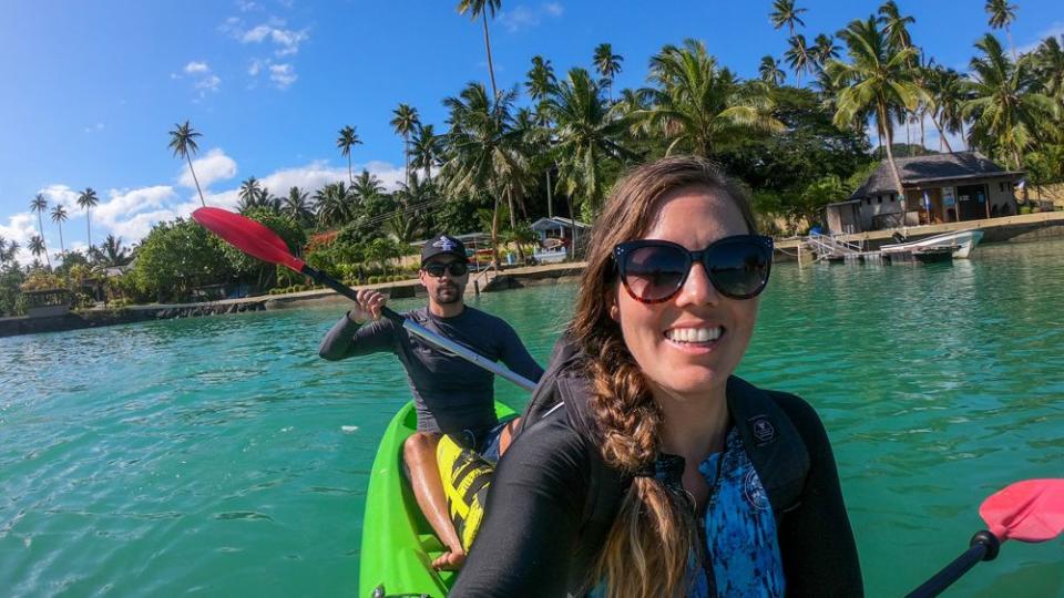 chantae reden in a tandem kayak with a male partner in the seat behind her