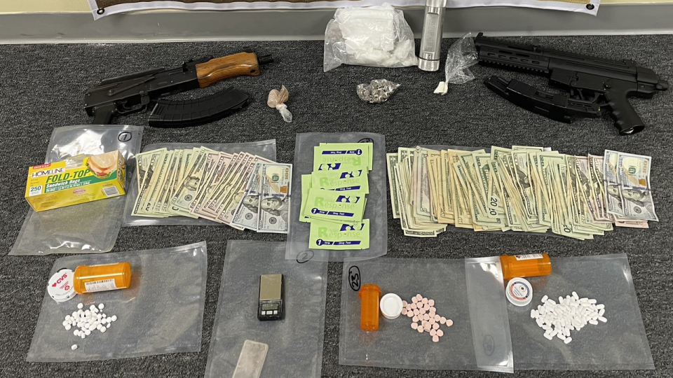 <div>Drugs, guns and money seized in a series of raids in Oakland County on May 2.</div>