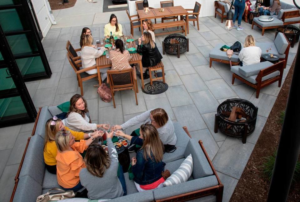 Patrons sit on the patio at RBF, Your Authentic Champagne Bar on Thursday, March 16, 2023, in Cary, N.C.