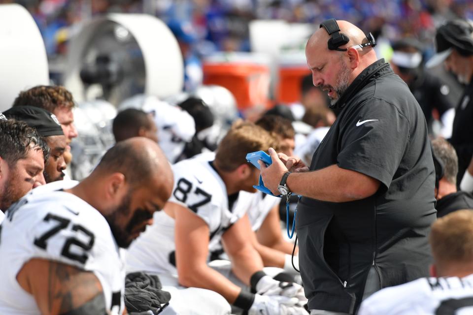 Las Vegas Raiders offensive line coach Carmen Bricillo uses a Microsoft Surface tablet during the first half of an NFL football game against the Buffalo Bills in Orchard Park, N.Y., Sunday, Sept. 17, 2023. (AP Photo/Adrian Kraus)