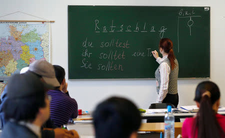 Migrants attend a lesson at the "institute for intercultural communication" in Berlin, Germany, April 13, 2016. REUTERS/Hannibal Hanschke