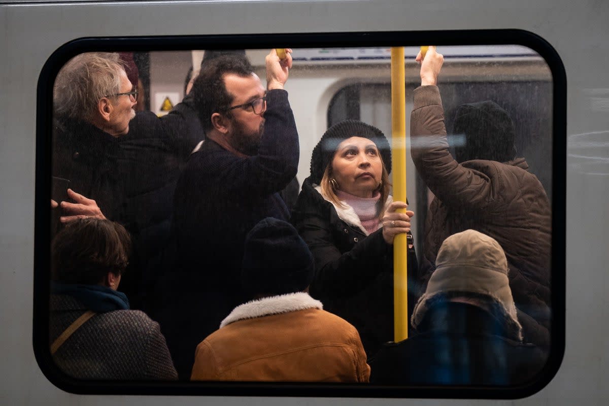 Passengers ride the London Underground  (PA)