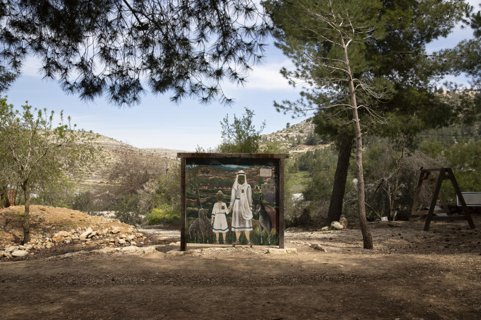 In this Tuesday, March 12, 2019 photo, a face cutout picture stand is provided for tourists at the archaeological site of Tel Shiloh in the West Bank. Deep in the West Bank, an Israeli settlement has transformed the archaeological site into a biblical tourist attraction that is drawing tens of thousands of Evangelical Christian visitors each year. Critics say the site promotes a narrow interpretation of history popular with Israeli settlers and their Christian supporters. (AP Photo/Sebastian Scheiner)