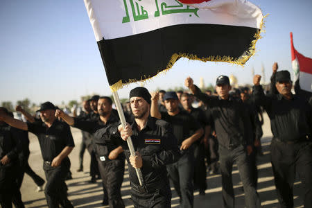 Mehdi Army fighters loyal to Shi'ite cleric Moqtada al-Sadr march during a military-style training in the holy city of Najaf, June 17, 2014. REUTERS/Ahmad Mousa