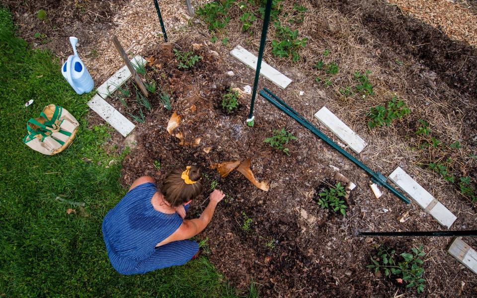 Jan Firebaugh works on her plot in the Willie Streeter Community Garden on Saturday, May 13, 2023.