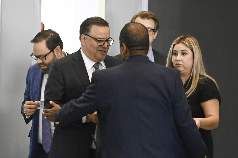 Derrel McDavid, center, walks into the Dirksen Federal Courthouse in Chicago after verdicts were reached in R. Kelly's trial, Two Kelly associates, Derrel McDavid and Milton Brown, are co-defendants. McDavid is accused of helping Kelly fix the 2008 trial, Wednesday, Sept. 14, 2022, in Chicago. A federal jury on Wednesday convicted R. Kelly of several child pornography and sex abuse charges in his hometown of Chicago, delivering another legal blow to a singer who used to be one of the biggest R&B stars in the world. (AP Photo/Matt Marton)