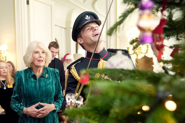 <p>Kin Cheung WPA Pool/Getty</p> Queen Camilla at the tree decorating event at Clarence House on Dec. 6.