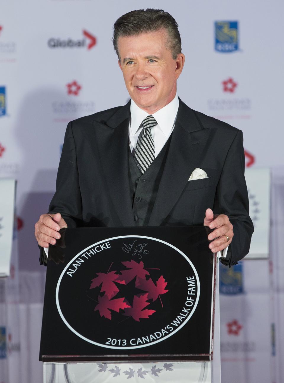 Actor Alan Thicke stands by his star during Canada's Walk of Fame induction ceremonies in Toronto, September 21, 2013. REUTERS/Mark Blinch (CANADA - Tags: ENTERTAINMENT)