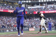 Los Angeles Dodgers' Mookie Betts, left, scores in front of San Francisco Giants catcher Curt Casali after pitcher Camilo Doval walked Will Smith with the bases during the fifth inning of a baseball game in San Francisco, Sunday, Sept. 5, 2021. (AP Photo/Jeff Chiu)